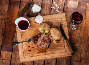 Steak with spices, thyme and chili served on a cutting board